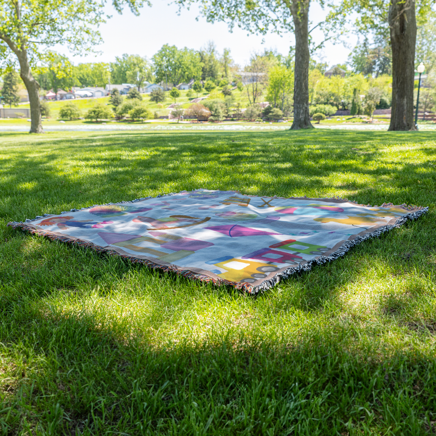 Kids toys girl woven throw blanket, on grass view
