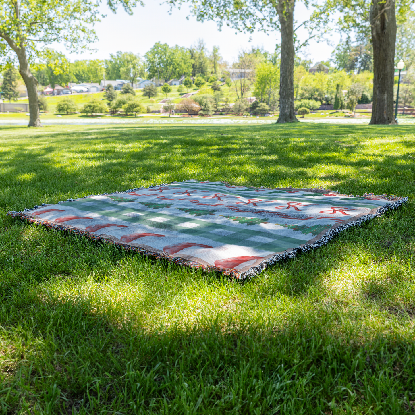 Modern Christmas woven throw blanket, on grass view