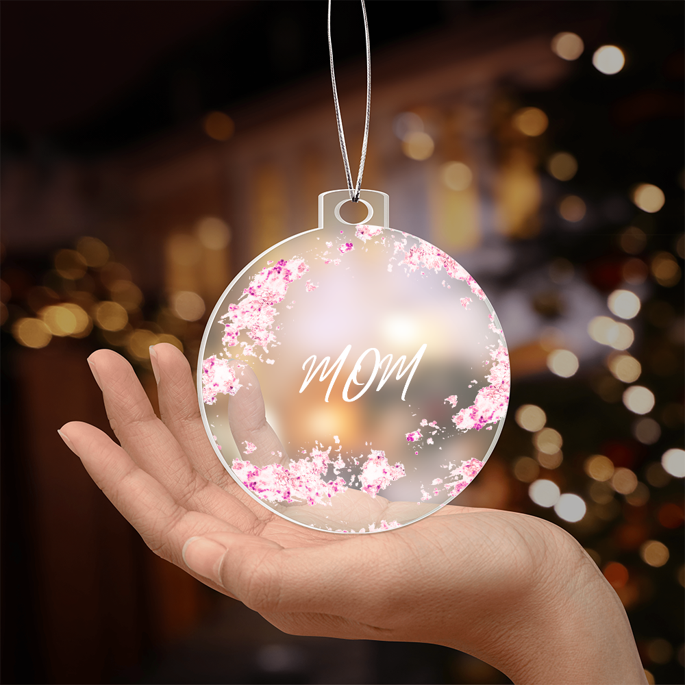 Mom Christmas ornament, pink, held in hand